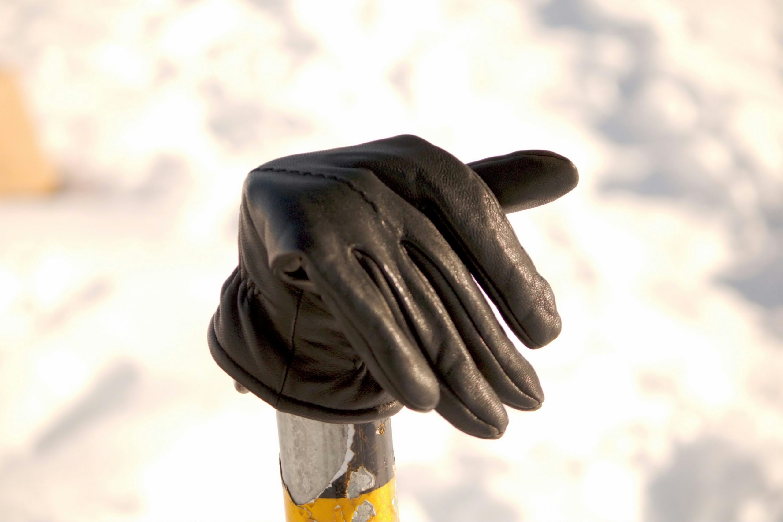 Close up of a plumber hands putting on gloves ready to work