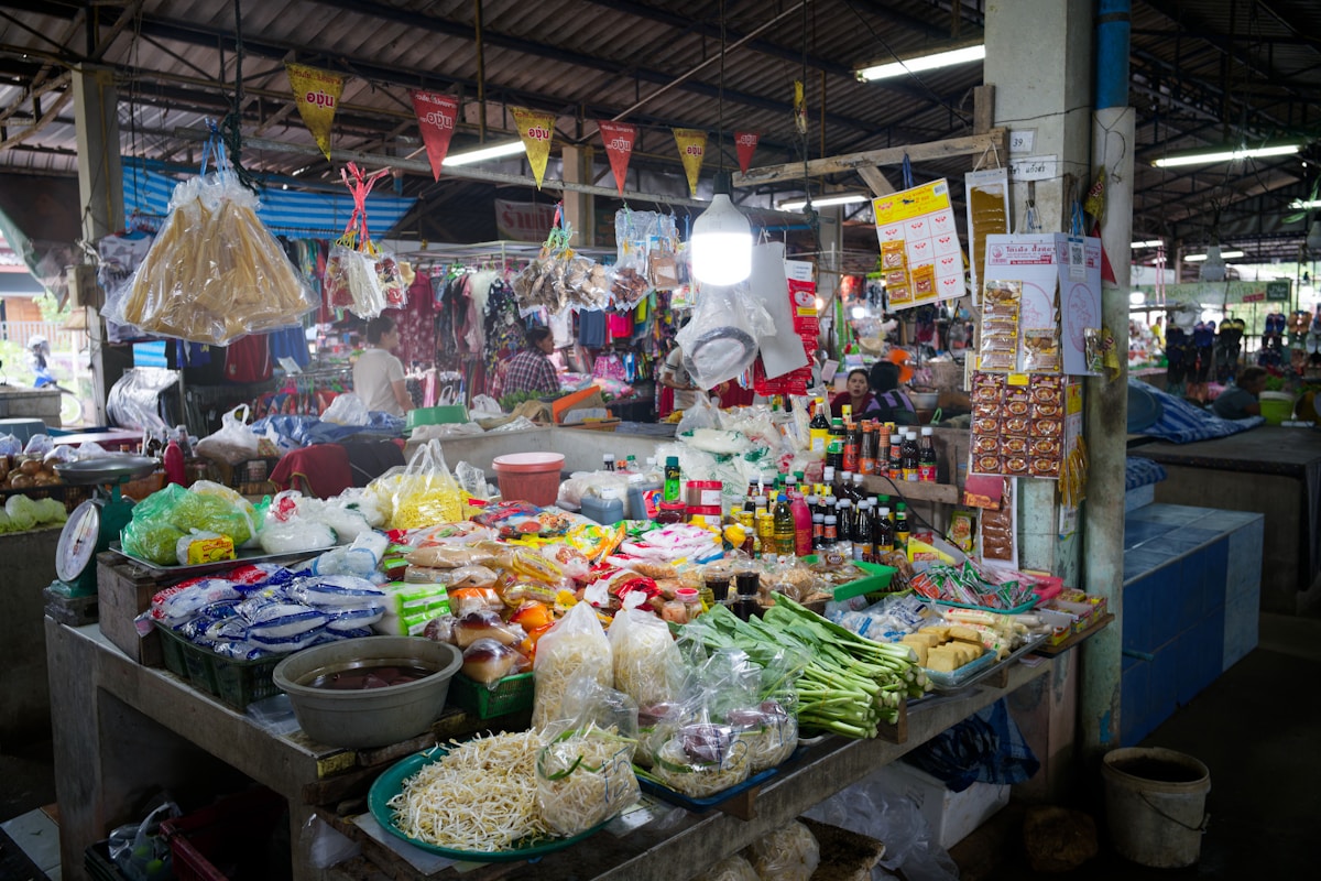 A busy market stall filled with fresh produce and goods.