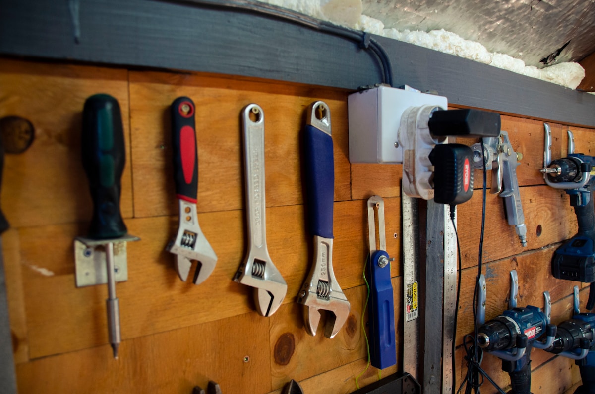 a bunch of tools are hanging on a wall