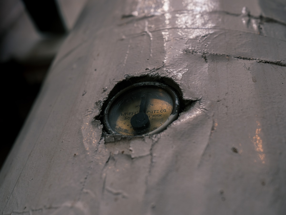 Close-up of a weathered, metallic eye on a cylindrical object.