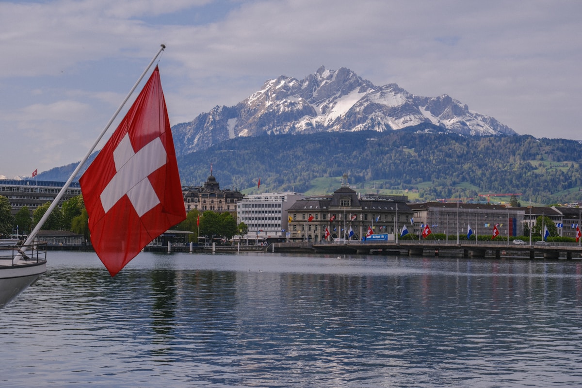 a swiss flag on a boat in the water
