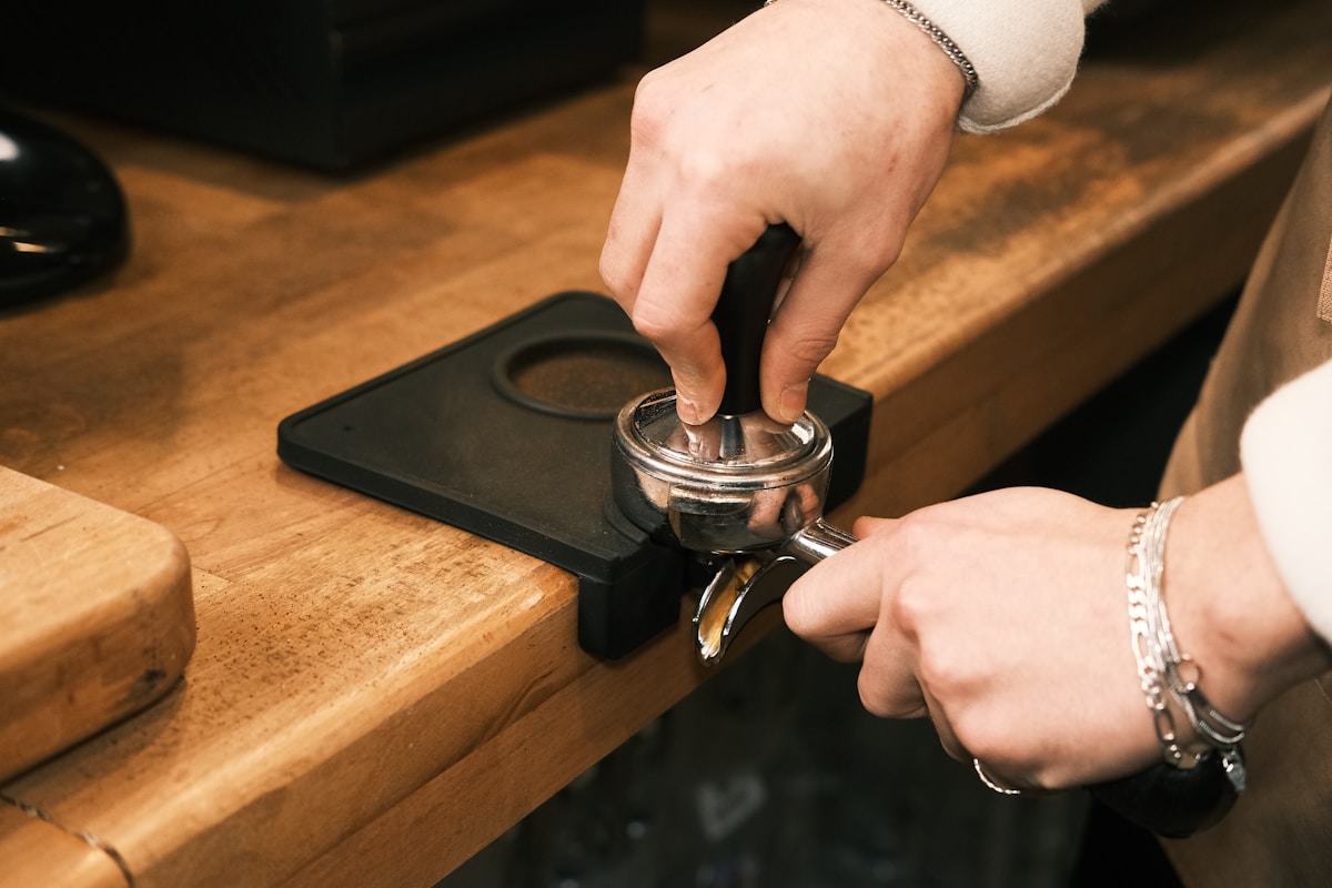 A person opening a bottle opener on a counter
