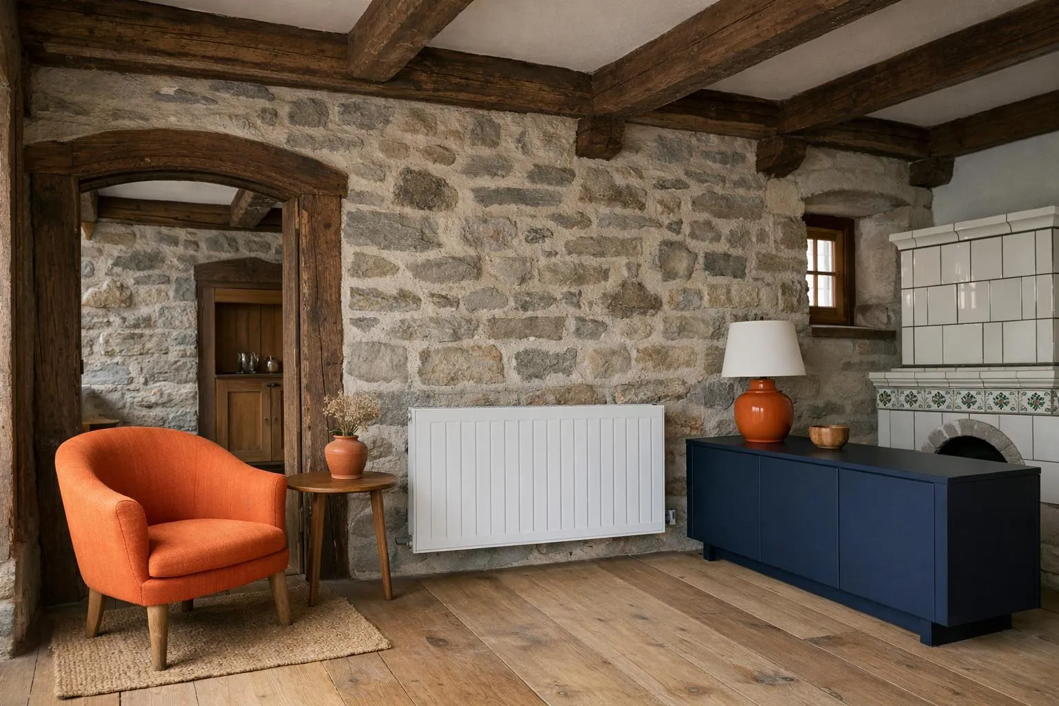Interior view of a traditional Swiss historic house showing thick exposed stone walls and old wooden ceiling beams, with a modern radiator installed, highlighting the contrast between old architecture and modern heating needs in Switzerland