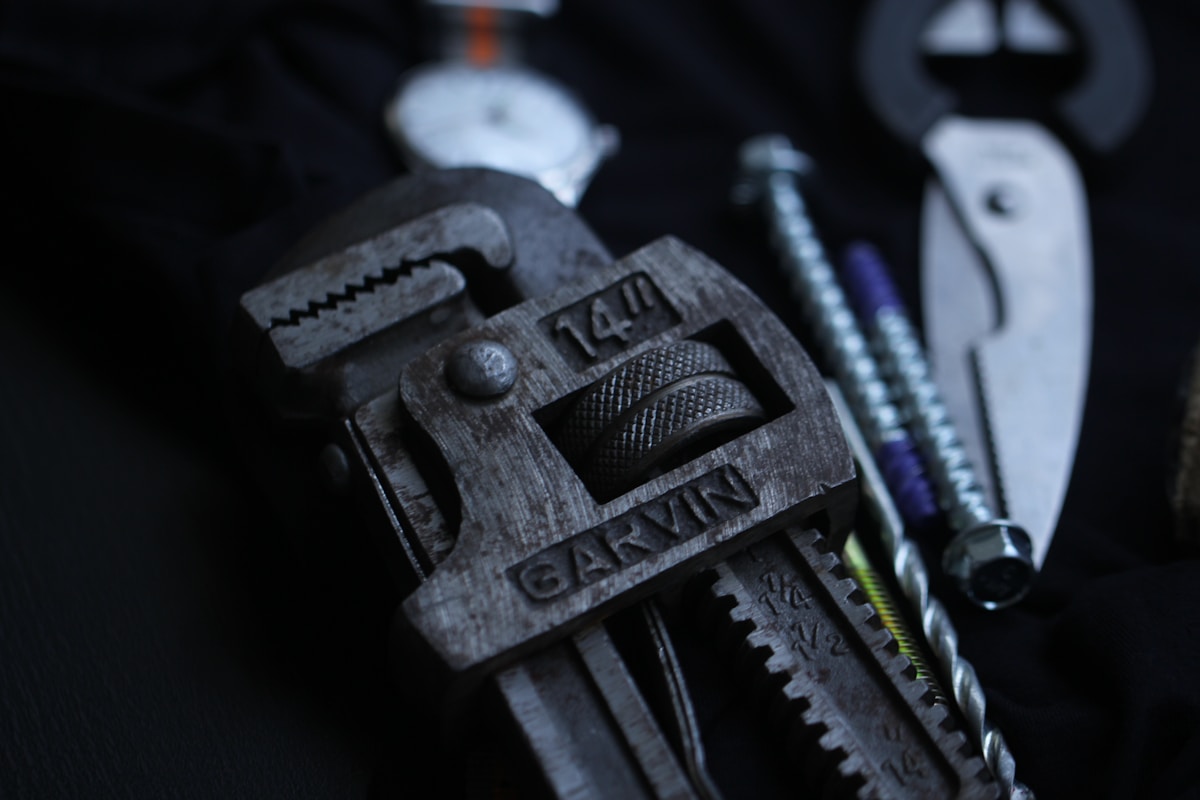 Outils de plomberie sombres et métalliques, gros plan.